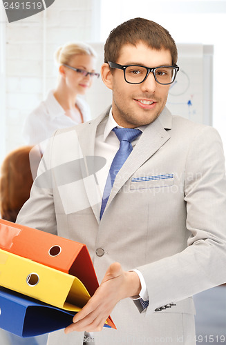 Image of businessman with folders in office