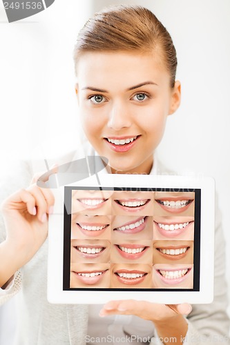 Image of female doctor with tablet pc and smiles