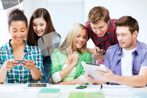 Image of students looking at smartphones and tablet pc