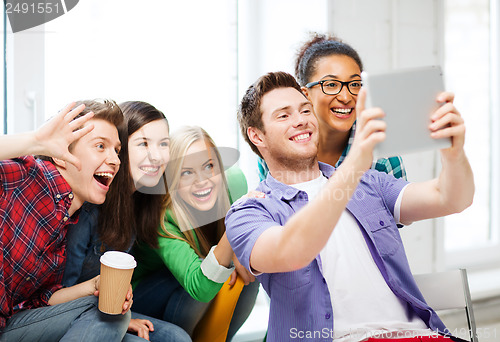 Image of students making picture with tablet pc at school