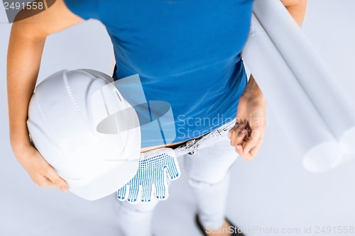 Image of woman architect with helmet and blueprint