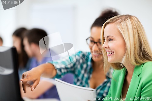 Image of students with computer studying at school