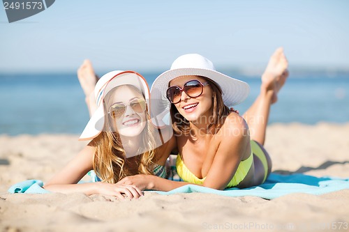 Image of girls sunbathing on the beach