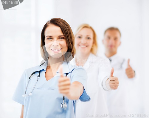 Image of team of doctors showing thumbs up