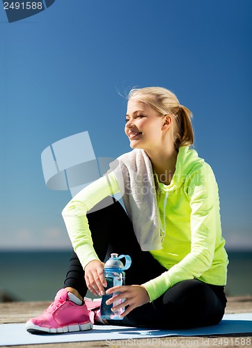 Image of woman resting after doing sports outdoors