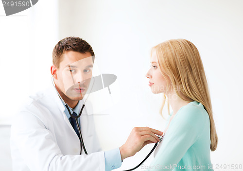 Image of doctor with stethoscope listening to the patient