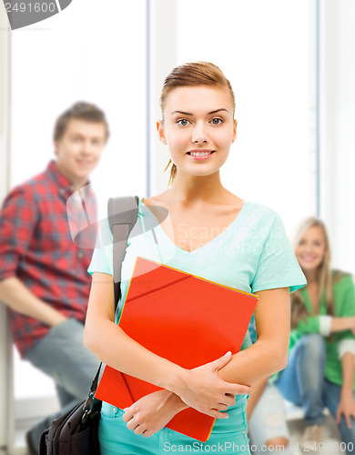 Image of student girl with folders and school bag