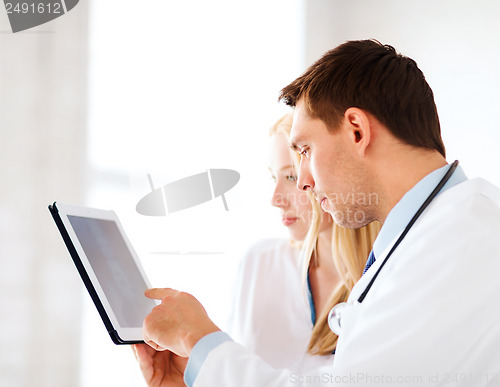 Image of two doctors looking at x-ray on tablet pc