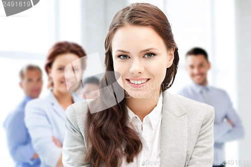 Image of attractive young businesswoman in office