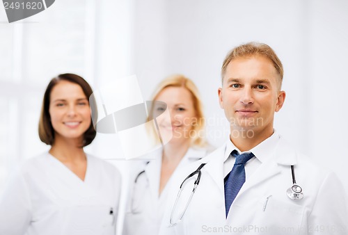 Image of doctor with stethoscope and colleagues