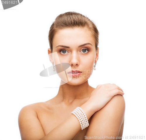 Image of beautiful woman with pearl earrings and bracelet