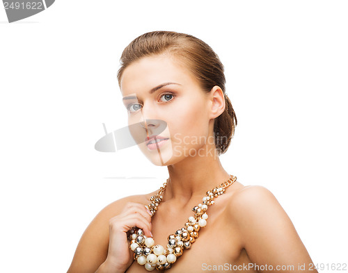 Image of woman wearing pearl statement necklace