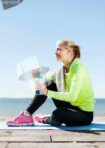 Image of woman resting after doing sports outdoors