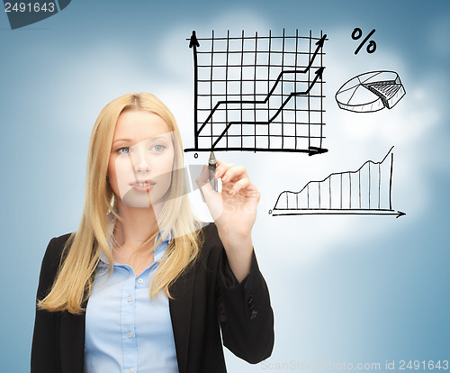 Image of businesswoman drawing graphs in the air