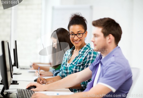 Image of african student with computer studying at school