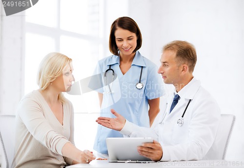 Image of doctor and nurse with patient in hospital