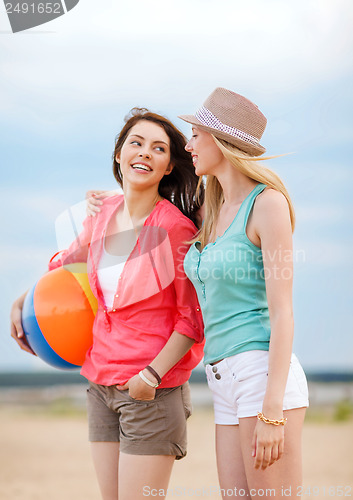 Image of girls playing ball on the beach