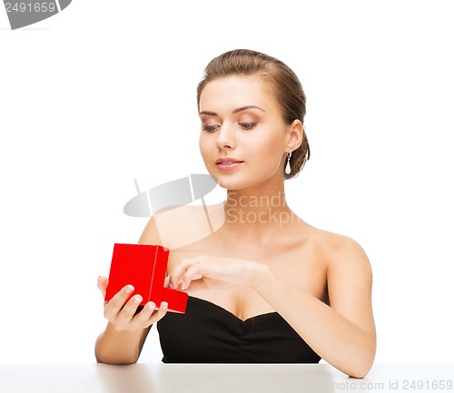 Image of woman with diamond earrings and gift box
