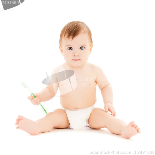 Image of curious baby brushing teeth