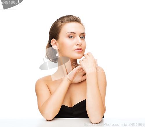 Image of woman with earrings and wedding ring