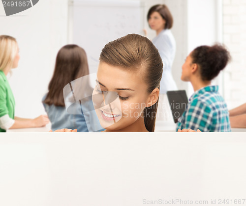 Image of smiling student girl with white blank board