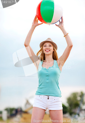 Image of girl playing ball on the beach