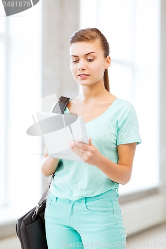 Image of smiling student with tablet pc in college