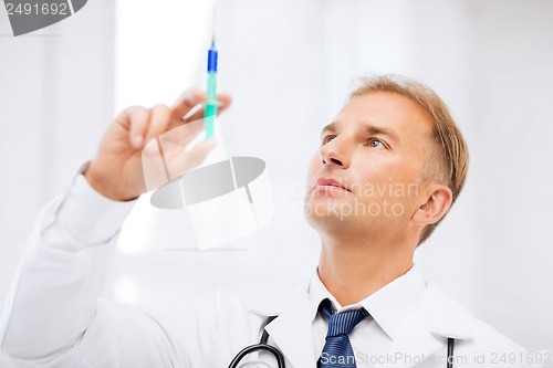 Image of male doctor holding syringe with injection