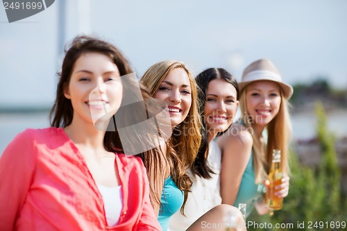 Image of girls with drinks on the beach