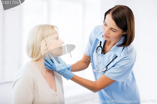 Image of plastic surgeon or doctor with patient