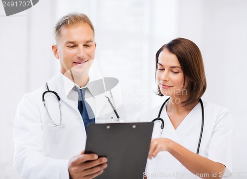 Image of two doctors writing prescription