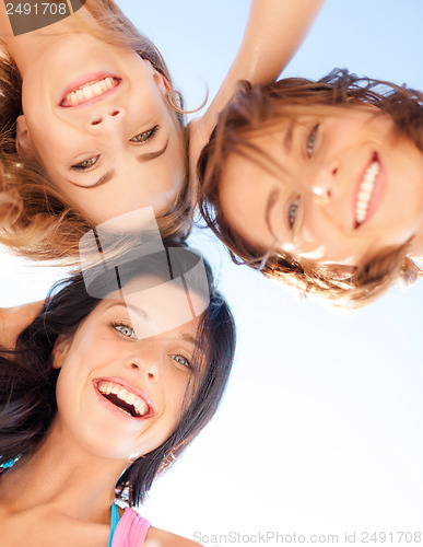 Image of girls faces with shades looking down