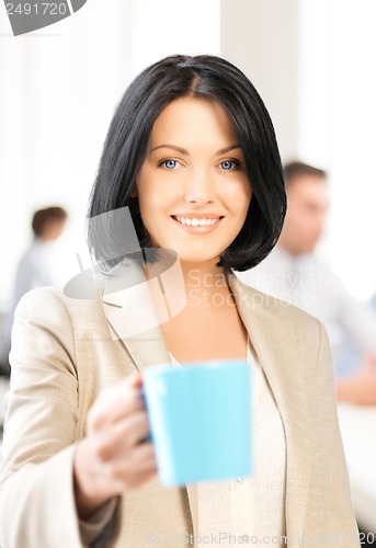 Image of beautiful businesswoman with cup of coffee