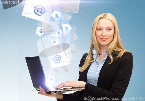 Image of businesswoman holding laptop with email sign