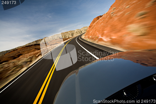 Image of car driving on road with motion blur