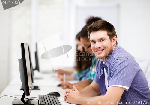 Image of student with computer studying at school