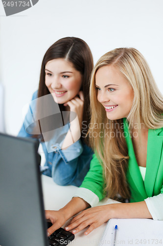 Image of students looking at tablet pc at school