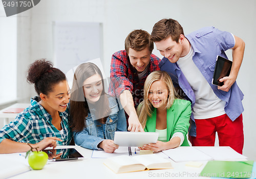 Image of students looking at tablet pc at school