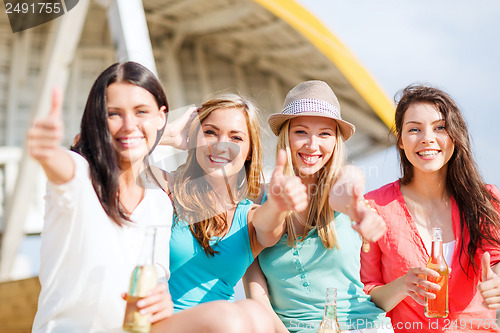 Image of girls with drinks on the beach