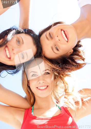 Image of girls faces with shades looking down