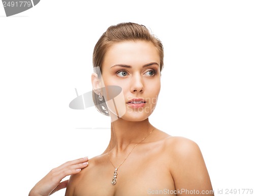 Image of woman wearing shiny diamond earrings