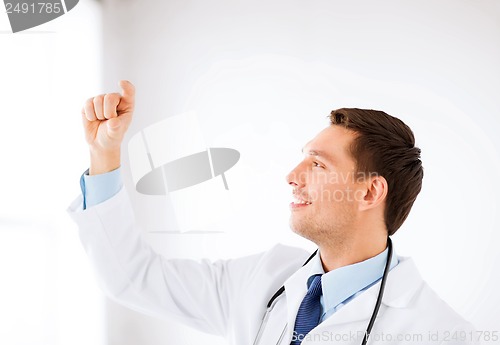 Image of young doctor holding something imaginary