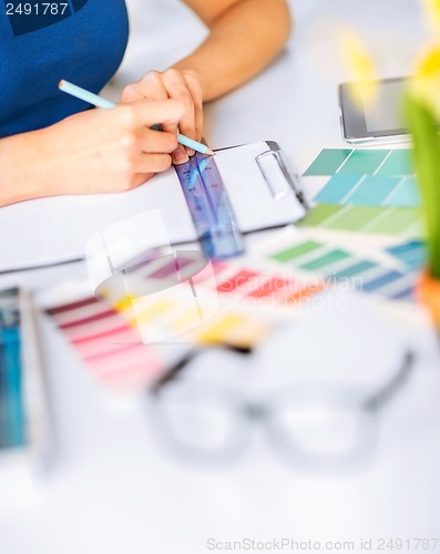 Image of woman working with color samples for selection