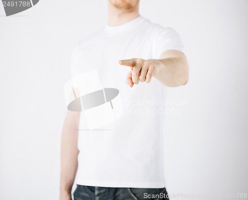 Image of man pointing his finger at you