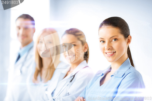 Image of female doctor in front of medical group