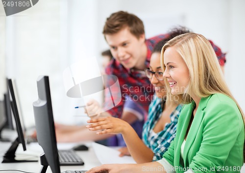 Image of students with computer studying at school