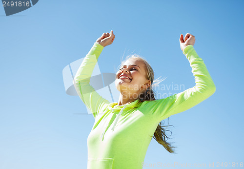 Image of woman runner celebrating victory