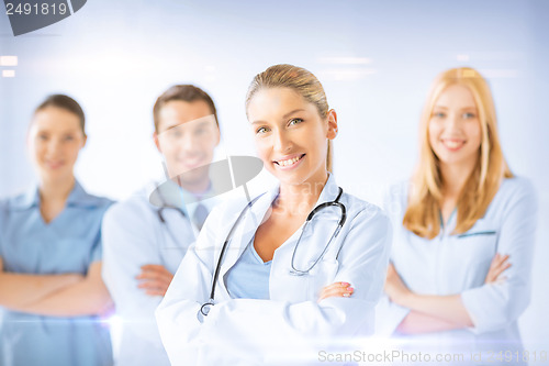 Image of female doctor in front of medical group