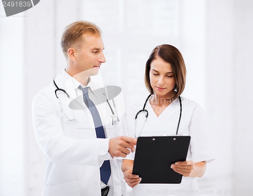 Image of two doctors writing prescription