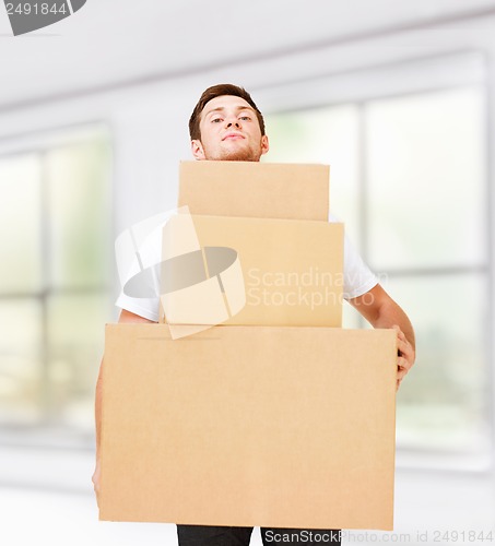 Image of young man carrying carton boxes